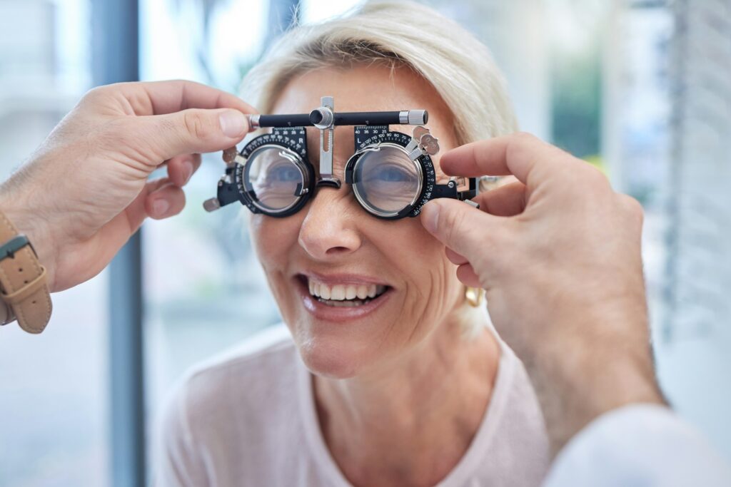 Happy customer in a vision test or eye exam for eyesight by doctor, optometrist or ophthalmologist